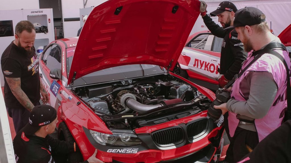 remaps exeter 9 men working on red car
